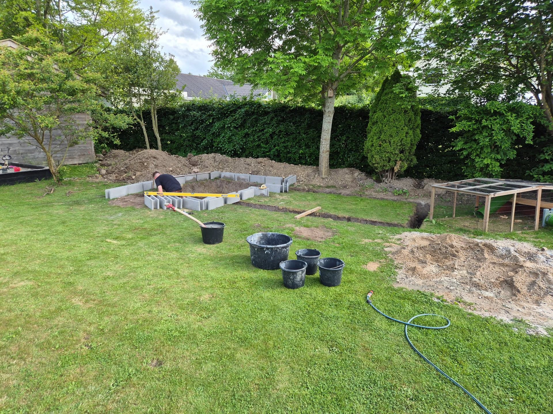 The dig in the garden, with buckets and a hosepipe